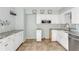 Bright kitchen with stainless steel appliances, farmhouse sink, granite countertops and white cabinetry at 200 S Bayshore Blvd, Clearwater, FL 33759