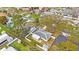 An aerial view shows a fenced property with a deck, lawn, and shed in a residential neighborhood at 22 Lake Shore Dr, Palm Harbor, FL 34684