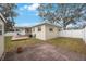 Spacious backyard with patio, privacy fence and mature trees at 22 Lake Shore Dr, Palm Harbor, FL 34684