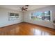 Bright living room with hardwood floors, a ceiling fan, and lots of natural light at 22 Lake Shore Dr, Palm Harbor, FL 34684