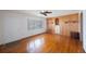 Spacious living room featuring hardwood floors, wood paneling, and a ceiling fan at 22 Lake Shore Dr, Palm Harbor, FL 34684