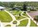 Beautiful aerial view of a community park with a pond, walking paths, and picnic tables at 2256 Spanish Dr # 42, Clearwater, FL 33763