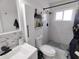 Bathroom featuring a white sink, toilet, shower with mosaic floors and black hardware at 2256 Spanish Dr # 42, Clearwater, FL 33763