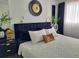 Beautiful bedroom with a modern black headboard, gold accents, and bright natural light at 2256 Spanish Dr # 42, Clearwater, FL 33763