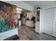 Open-concept kitchen with white cabinets, hardwood floors, and stainless steel appliances at 2256 Spanish Dr # 42, Clearwater, FL 33763