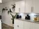 Modern kitchen with granite countertops, white cabinets, and decorative plant accents at 2256 Spanish Dr # 42, Clearwater, FL 33763