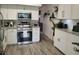 This kitchen offers white cabinetry, stainless steel appliances, granite counters and hardwood floors at 2256 Spanish Dr # 42, Clearwater, FL 33763