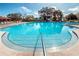 Resort-style swimming pool with multiple lounge chairs and umbrellas at 2256 Spanish Dr # 42, Clearwater, FL 33763