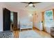 Pink room with wood floors, white furniture, and a changing table next to a window at 2427 Comerwood Dr, Spring Hill, FL 34609
