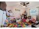 A colorful bedroom featuring a vibrant playmat and filled with plush toys at 2427 Comerwood Dr, Spring Hill, FL 34609