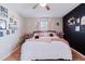 Cozy bedroom featuring stylish décor, a comfortable bed, and a black accent wall at 2427 Comerwood Dr, Spring Hill, FL 34609