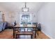 Open dining area featuring modern light fixture and view of the back yard through sliding glass doors at 2427 Comerwood Dr, Spring Hill, FL 34609