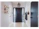 Bright entryway featuring tile flooring, modern lighting, and convenient coat hooks at 2427 Comerwood Dr, Spring Hill, FL 34609