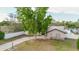 Spacious home featuring a long driveway, fenced yard, and mature tree at 2427 Comerwood Dr, Spring Hill, FL 34609