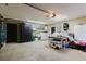 Bright garage with speckled flooring, laundry area, and storage cabinets at 2427 Comerwood Dr, Spring Hill, FL 34609