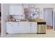 The kitchen features white cabinets, a stainless steel dishwasher, and butcher block countertops at 2427 Comerwood Dr, Spring Hill, FL 34609