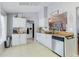 Bright kitchen with white cabinets, stainless steel dishwasher, and stylish butcher block countertops at 2427 Comerwood Dr, Spring Hill, FL 34609