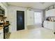 Bright kitchen featuring white cabinets, stainless steel appliances, and a black pantry door at 2427 Comerwood Dr, Spring Hill, FL 34609