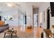 Open-concept living room with hardwood floors, ceiling fan, and ample natural light at 2427 Comerwood Dr, Spring Hill, FL 34609
