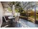 An enclosed patio area with outdoor seating and a view of the backyard at 2427 Comerwood Dr, Spring Hill, FL 34609