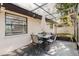 A covered patio featuring a dining table and seating, perfect for outdoor entertaining at 2427 Comerwood Dr, Spring Hill, FL 34609