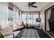 A light filled sunroom featuring comfortable seating, large windows, and a geometric rug at 2427 Comerwood Dr, Spring Hill, FL 34609