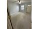 Bedroom with neutral carpet, a window, and a door to the exterior at 2900 W Azeele St # H, Tampa, FL 33609