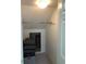 View of a walk-in closet with white walls and a clothes rod. A large storage area and an overhead light are also visible at 2900 W Azeele St # H, Tampa, FL 33609