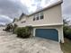 Inviting townhome showcasing a private garage and complemented by tropical landscaping at 2900 W Azeele St # H, Tampa, FL 33609