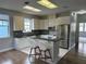 Modern kitchen featuring white cabinets, stainless steel appliances, and a breakfast bar with seating at 2900 W Azeele St # H, Tampa, FL 33609