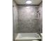 Close up of a shower with contemporary neutral tile work and modern shower head with tub at 2900 W Azeele St # H, Tampa, FL 33609