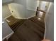 A staircase with hardwood steps and white risers leading to the main floor at 2900 W Azeele St # H, Tampa, FL 33609