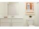 Stylish bathroom with a white vanity, framed mirror, and modern fixtures at 36083 Joseph Blake St, Zephyrhills, FL 33541