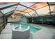 Screened-in pool with a fountain and seating area at 415 Oakmount Rd, Clearwater, FL 33765