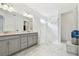 Main bathroom featuring double sinks and a walk in shower at 4228 Isonzo Way, Wesley Chapel, FL 33543