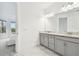 Main bathroom featuring double sinks and an ensuite bathroom at 4228 Isonzo Way, Wesley Chapel, FL 33543