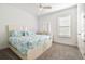 Cozy bedroom with a ceiling fan and a comfortable bed featuring bright blue floral bedding at 4228 Isonzo Way, Wesley Chapel, FL 33543