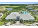 Aerial view of the community clubhouse, featuring a pool, tennis courts, and lush landscaping at 4228 Isonzo Way, Wesley Chapel, FL 33543