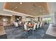 The dining area is expansive and well-lit with tables and chairs set for an inviting dining experience at 4228 Isonzo Way, Wesley Chapel, FL 33543