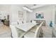 Elegant dining area features a glass table with ample seating and bright, modern decor at 4228 Isonzo Way, Wesley Chapel, FL 33543
