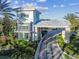 A close up of the gated entrance, with manicured landscaping and a stylish architectural design at 4228 Isonzo Way, Wesley Chapel, FL 33543