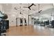 Bright gym with wood floors, mirrored walls, ceiling fans, and weights at 4228 Isonzo Way, Wesley Chapel, FL 33543