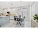 Bright kitchen features a modern dining table, center island, marble floors, stainless steel appliances at 4228 Isonzo Way, Wesley Chapel, FL 33543