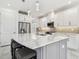 A gourmet kitchen featuring a large center island with seating, white cabinets, and stainless steel appliances at 4228 Isonzo Way, Wesley Chapel, FL 33543