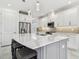 A gourmet kitchen featuring a large center island with seating, white cabinets, and stainless steel appliances at 4228 Isonzo Way, Wesley Chapel, FL 33543