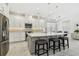 Bright kitchen features a center island, marble floors, stainless steel appliances, and modern pendant lighting at 4228 Isonzo Way, Wesley Chapel, FL 33543