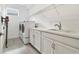 Well-equipped laundry room boasts modern washer and dryer, ample counter space, and convenient storage shelves at 4228 Isonzo Way, Wesley Chapel, FL 33543