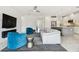 Open-concept living area blends modern design with plush seating, a fireplace, and a seamless connection to the kitchen at 4228 Isonzo Way, Wesley Chapel, FL 33543