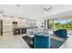 Spacious living area showcases modern furnishings, an adjacent kitchen, and sliding glass doors to the outdoor space at 4228 Isonzo Way, Wesley Chapel, FL 33543