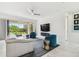 Bright living room featuring modern furnishings, a sleek ceiling fan, and access to the outdoor lanai at 4228 Isonzo Way, Wesley Chapel, FL 33543